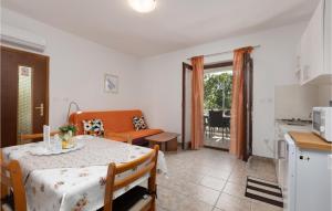 a kitchen and a dining room with a table in a room at 1 Bedroom Amazing Apartment In Krk in Krk