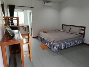 a small bedroom with a bed and a desk at Lovely Paradise Phangan Hotel in Thongsala +46 photos