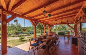 a wooden patio with a long table and chairs at 5 Bedroom Awesome Home In Ledenice in Ledenice +41 photos