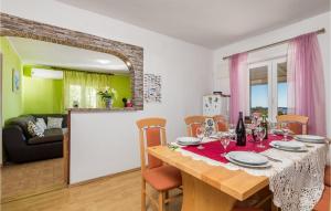a dining room and living room with a table and chairs at Beautiful Home In Jablanac With Wifi in Jablanac