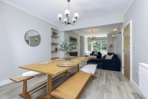 a living room with a table and a couch at Eller Cottage in Windermere