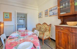 a dining room with a table and a chair at 2 Bedroom Lovely Apartment In Genova in Genova