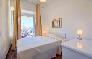 a white bedroom with a bed and a balcony at 2 Bedroom Lovely Apartment In Genova in Genova