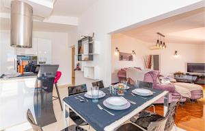 a kitchen and living room with a table and chairs at Lovely Home In Brodarica With Jacuzzi in Brodarica