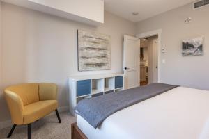 a bedroom with a bed and a chair at New 1Bd Luxe King Suite with Superb Mtn View in Canmore