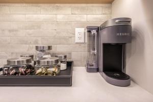 a kitchen counter with a kettleton coffee machine on it at New 1Bd Luxe King Suite with Superb Mtn View in Canmore