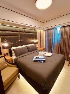 a bedroom with a large bed with a towel on it at Serenity Bali Condotel in San Fernando