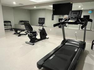 a gym with several exercise bikes and a flat screen tv at New 1Bd Luxe King Suite with Superb Mtn View in Canmore
