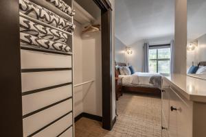 a room with a bedroom with a bed and a closet at Stunning Silver Creek 1Br Mtn view penthouse in Canmore