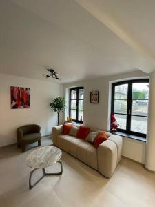 a living room with a couch and a table at Maison alsacienne in Sélestat