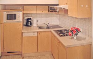 a kitchen with a sink and a stove top oven at Ferienwohnung In Ischgl in Ischgl