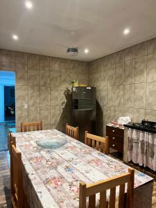 a kitchen with a table with chairs and a refrigerator at Casa Eliane in Paraty +30 photos