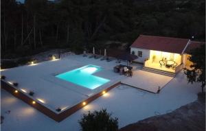 an overhead view of a swimming pool at night at Lovely Home In Supetar in Supetar +23 photos
