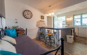a living room with a table and a clock on the wall at Awesome Home In Nevidane With Wifi in Neviđane