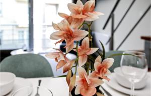 a vase filled with pink flowers on a table at Residentie Zeezicht in Ostend