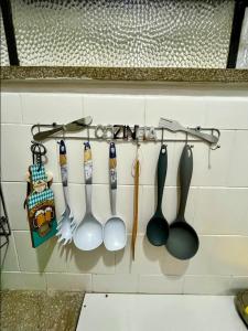 a group of utensils hanging on a wall at Studio no Largo da Carioca - Rio de Janeiro in Rio de Janeiro +138 photos