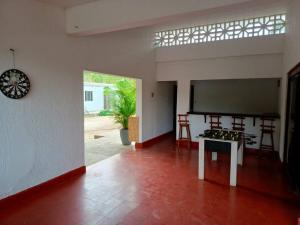 a living room with a table and a large screen at campestre, naturaleza, confort, familiar in Turbaco