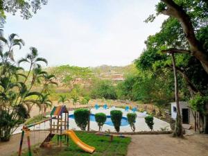 a playground with a swimming pool and a slide at campestre, naturaleza, confort, familiar in Turbaco