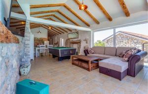 a living room with a couch and a pool table at Two-Bedroom Holiday Home In Smrika in Šmrika
