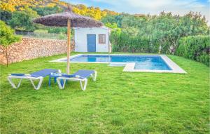 einen Pool mit 2 Liegestühlen und einem Sonnenschirm in der Unterkunft 5 Bedroom Awesome Home In Ubrique in Ubrique