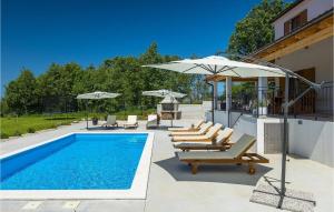 a swimming pool with lounge chairs and an umbrella at Villa Roza-Dolinci in Sveti Petar u Šumi