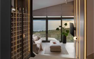 a living room with a couch and a large window at Villa Brilliance House in Orebić