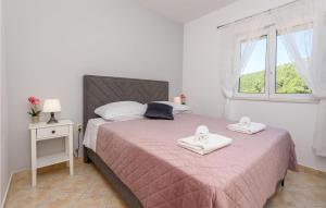 a bedroom with a bed with two towels on it at 1 Bedroom Awesome Apartment In Klek in Klek