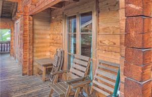 two chairs and a table on the porch of a cabin at Ferienhaus In Wagrain in Wagrain