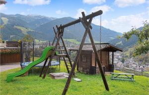 a playground with a slide and a swing set at Ferienhaus In Wagrain in Wagrain