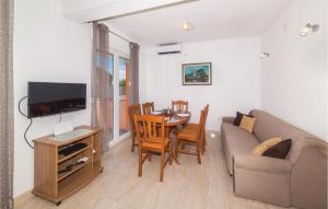a living room with a couch and a dining room table at Cozy Apartment In Sevid With Wifi in Sevid