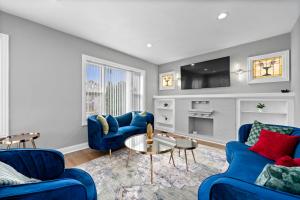芝加哥Emmanuel Haven的客厅配有2张蓝色沙发和电视