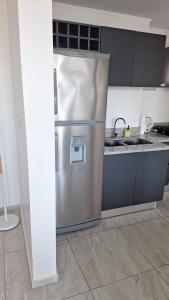 a kitchen with a stainless steel refrigerator at Torre Charlotte in Posadas