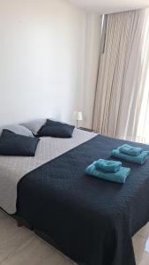 a bedroom with a bed with two towels on it at Torre Charlotte in Posadas +13 photos