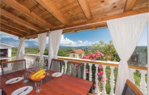 a wooden table on the balcony of a house at One-Bedroom Holiday Home In Danilo in Danilo Biranj