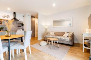 a living room with a table and a couch at Marina Luna - widok na jezioro, parking podziemny, winda, Netflix, Max in Iława +30 photos