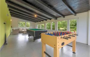 a living room with a table and a pool table at Lovely Home In Stikada With Sauna in Štikada