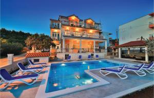 a house with a swimming pool in front of a house at Nice Apartment In Poljica in Poljica
