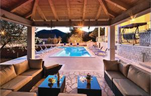 an outdoor patio with a swimming pool with couches at Nice Apartment In Poljica in Poljica +14 photos