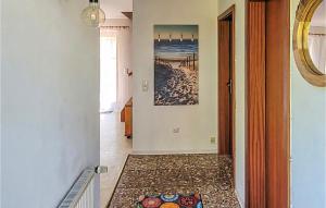 a hallway with a tile floor in a home at Amazing Home In Prerow With Wifi in Prerow +4 photos