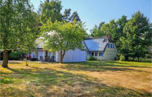 a house with a solar roof with a yard at Amazing Home In Prerow With Wifi in Prerow