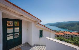 a door to a building with a view of a river at Amazing Apartment In Rabac With Kitchen in Rabac +21 photos