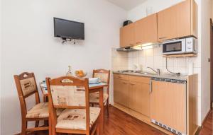 a small kitchen with a table and a microwave at Awesome Apartment In Moscenicka Draga in Kraj