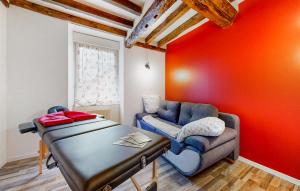 a living room with a couch and a suitcase at Amazing Home In Neuilly Le Vendin in Neuilly-le-Vendin
