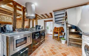 a kitchen with a sink and a stove at Amazing Home In Neuilly Le Vendin in Neuilly-le-Vendin