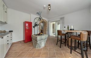eine Küche mit einem roten Kühlschrank und einem Tisch in der Unterkunft Villa Mirys Hideaway in Dobrinj