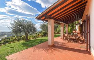 a patio with a table and chairs on a house at 4 Bedroom Nice Home In Pietrasanta in Pietrasanta