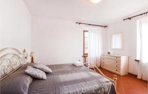 a white bedroom with a large bed and a dresser at 4 Bedroom Nice Home In Pietrasanta in Pietrasanta