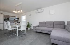 a living room with a couch and a table and chairs at Lovely Home In Donji Prolozac With Wifi in Donji Proložac +19 photos