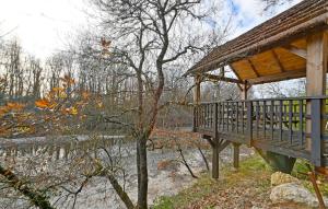 a wooden gazebo next to a tree at 1 Bedroom Awesome Home In Saint-Denis in Saint-Denis +8 photos