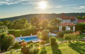 a house with a swimming pool in a yard at Stunning Home In Labin in Labin
